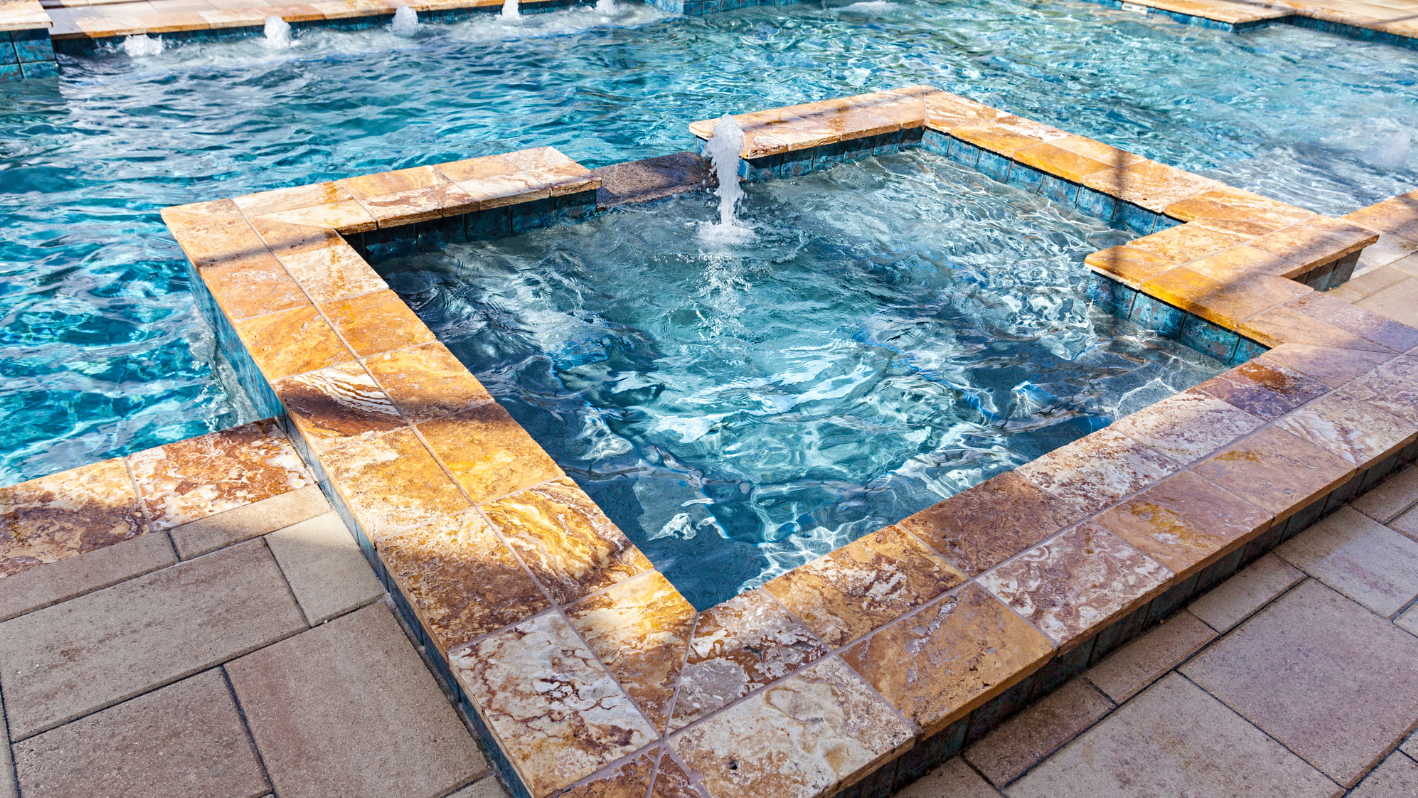 A swimming pool with a fountain in the middle of it